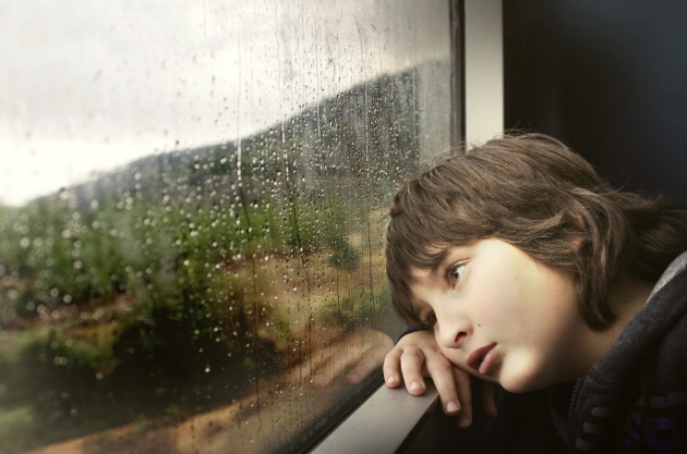 image of child on a train looking out the window