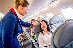 Flight attendant speaking to a passenger about her airsickness
