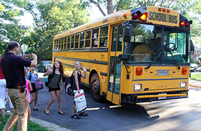 Kids getting on a school bus