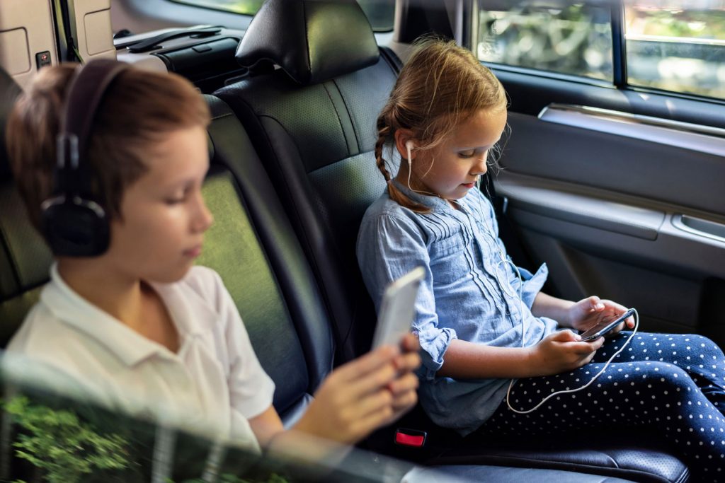 Children using phones to watch games