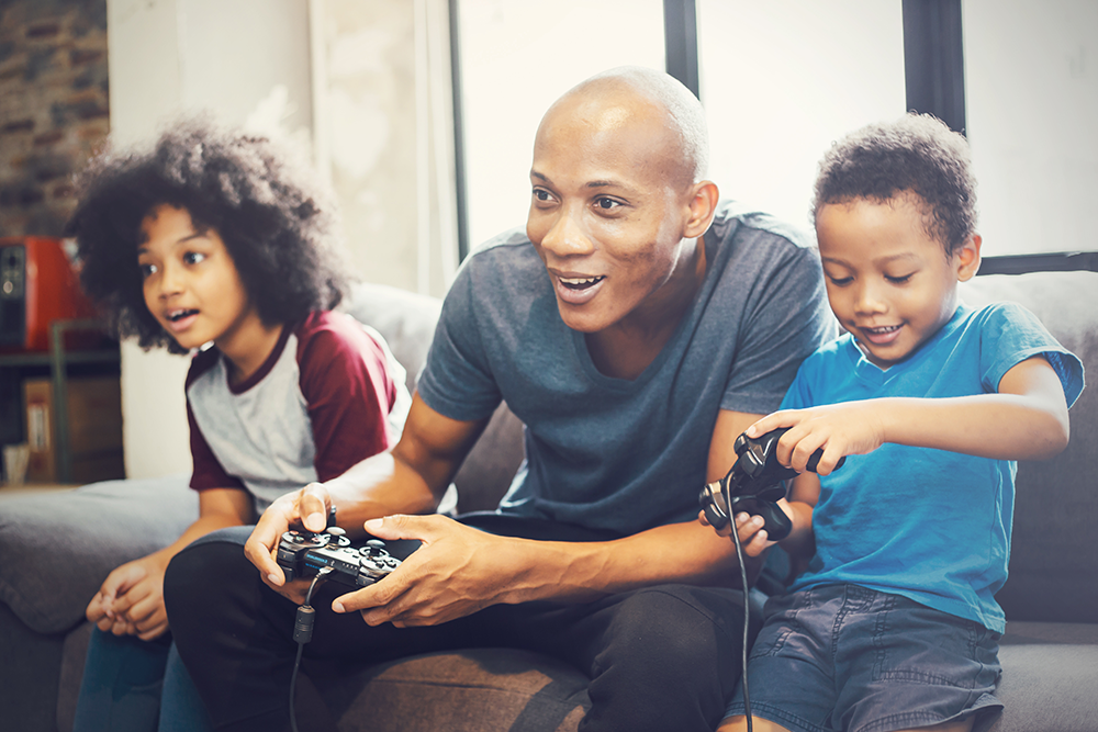 dad playing video games with his kids